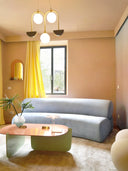 sofa curvo tapizado color celeste moderno