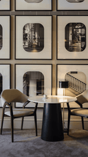 Sophisticated hotel lobby in Amsterdam with premium European furniture, marble flooring, oak wood accents, natural lighting, serene ambiance