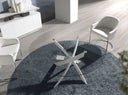 Mesa comedor redonda de cristal templado con patas de acero en aspa acabado blanco, en un comedor decorado