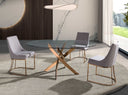 Mesa comedor redonda de cristal templado con patas de acero en aspa acabado oro rosa, en un comedor decorado