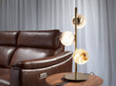 Lampara de sobremesa de acero inoxidable dorado con esferas de cristal estampado.