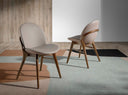 Silla de diseño moderno con asiento y respaldo tapizados en polipiel color visón oscuro.
