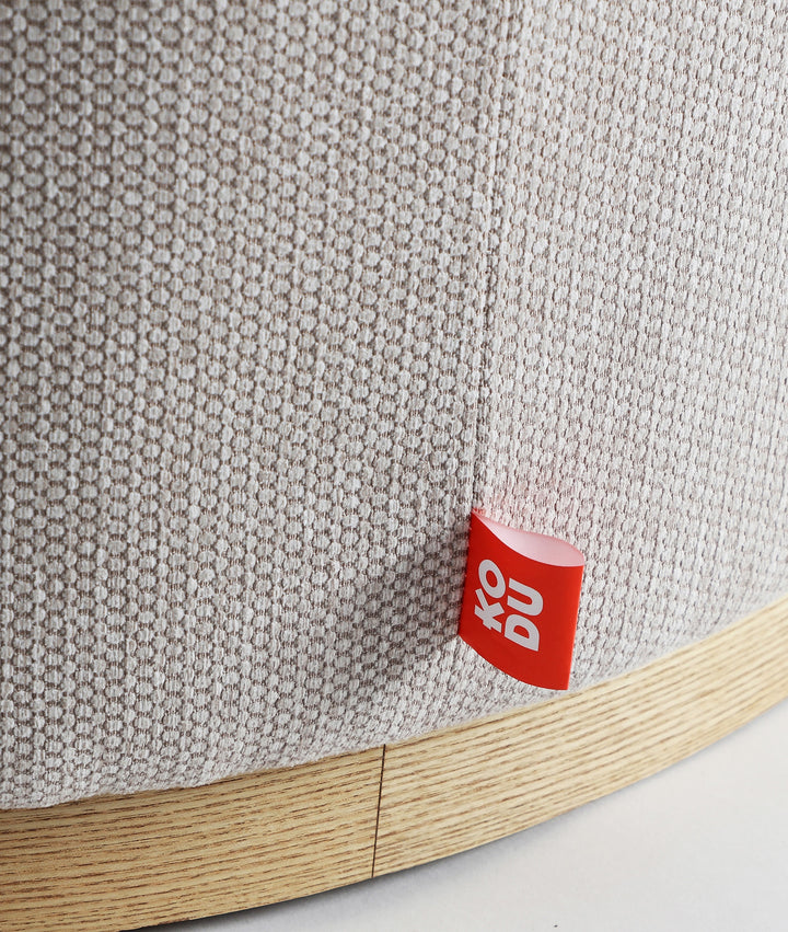 Repose-pieds RUREY rond en tissu avec socle en bois massif