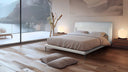Cama tapizada con cabecero bajo envolvente y patas metálicas – ambiente