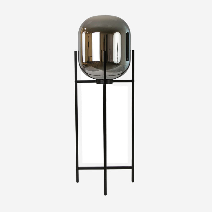 Lámpara de pie cristal efecto espejo fumé gris y acero negro sobre fondo gris de estudio