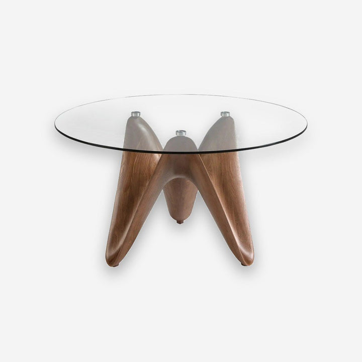 Mesa comedor redonda cristal templado y nogal sobre fondo gris de estudio