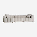 Sofá modular tapizado en poliéster en color gris con módulos acolchados