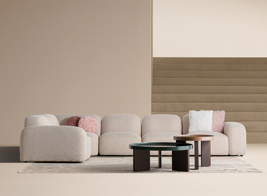 Minimalist living room: one modular sofa and two low tables in an uncluttered space