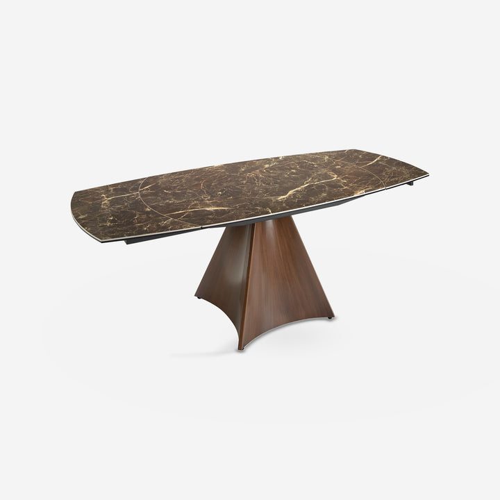 Mesa comedor extensible ovalada barril mármol porcelánico y acero efecto nogal sobre fondo gris de estudio