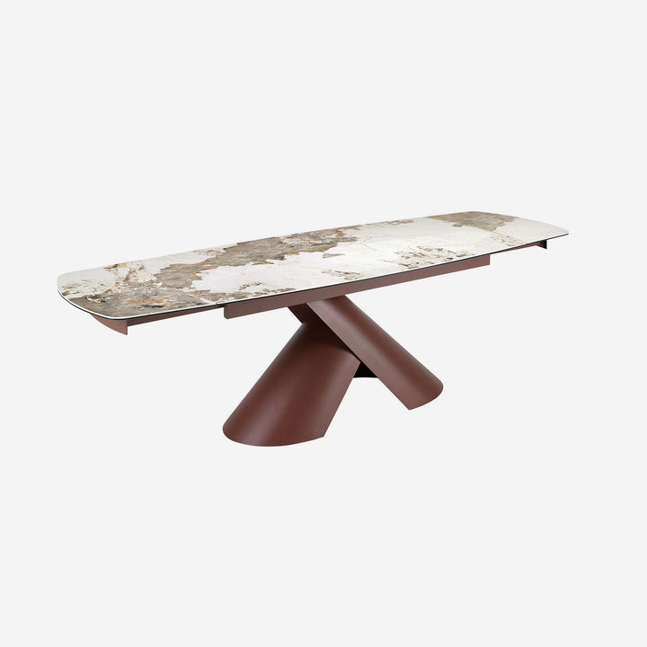 Mesa comedor extensible ovalada barril mármol porcelánico y acero marrón cobrizo sobre fondo gris de estudio