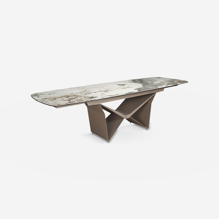 Mesa comedor extensible ovalada barril mármol porcelánico y acero taupé metalizado sobre fondo gris de estudio