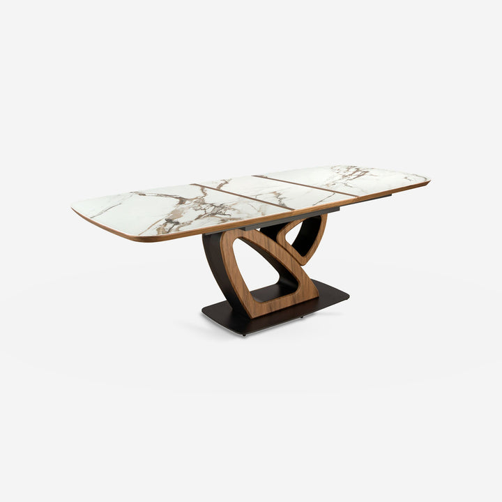 Mesa comedor extensible ovalada barril mármol porcelánico y nogal sobre fondo gris de estudio