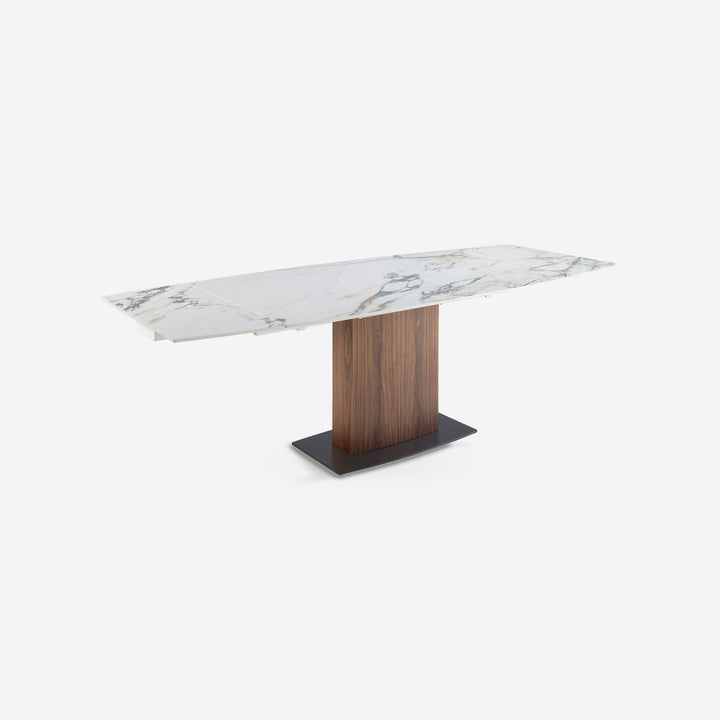 Mesa comedor extensible ovalada barril mármol porcelánico y nogal sobre fondo gris de estudio