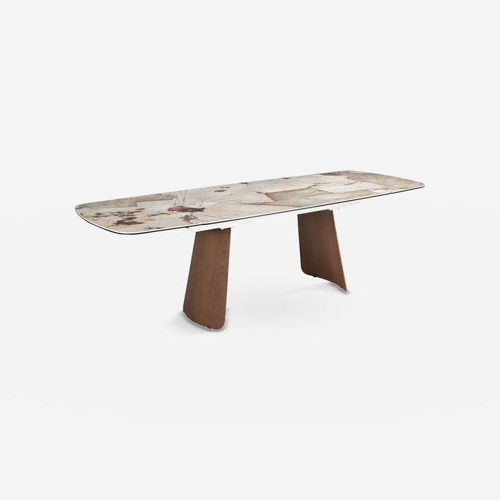Mesa comedor extensible ovalada barril mármol porcelánico y nogal sobre fondo gris de estudio