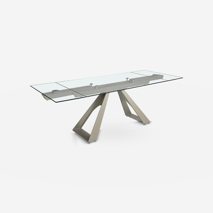 Mesa comedor extensible rectangular cristal templado y acero color champagne sobre fondo gris de estudio