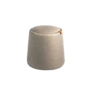 puff gris claro de tela, diseño minimalista con asa lateral en cuero para fácil transporte