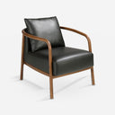 Sillón piel negro sobre fondo gris de estudio
