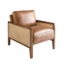 sillón vintage con cojines de piel color miel, brazos y patas de madera de nogal, y laterales en rejilla trenzada